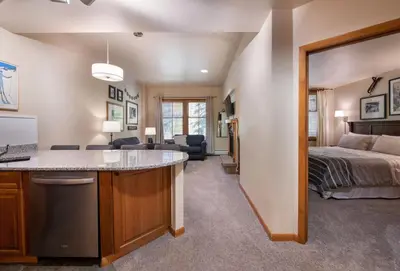 a living room and bedroom with a bed and a kitchen at Zephyr Mountain Lodge Premium-Rated 2108 in Winter Park