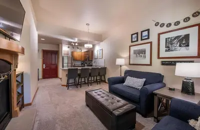 a living room with a couch and a dining room at Zephyr Mountain Lodge Premium-Rated 2108 in Winter Park