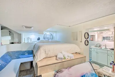 a bedroom with a large bed and a sink at Steps to City Park and Restaurants Denver Studio in Denver