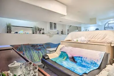 a room with a couch and a painting on the floor at Steps to City Park and Restaurants Denver Studio in Denver