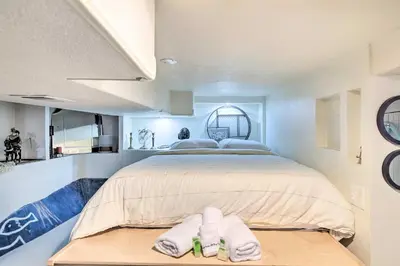 a bedroom with a large bed with two towels on a table at Steps to City Park and Restaurants Denver Studio in Denver