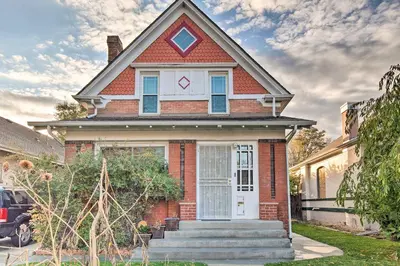 a red brick house with a white door at Steps to City Park and Restaurants Denver Studio in Denver