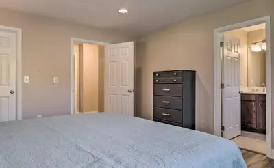 a bedroom with a large bed and a dresser at Walk to Broncos Stadium Modern Denver Duplex in Denver