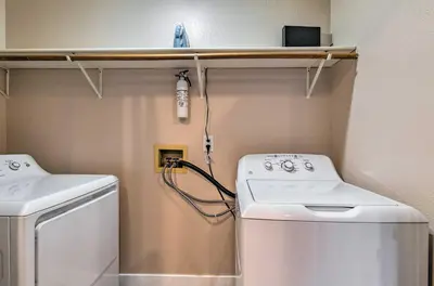 a small laundry room with a washer and dryer at Walk to Broncos Stadium Modern Denver Duplex in Denver