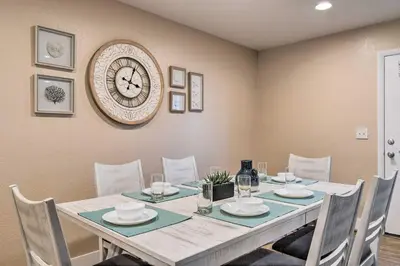 a dining room with a table and a clock on the wall at Walk to Broncos Stadium Modern Denver Duplex in Denver