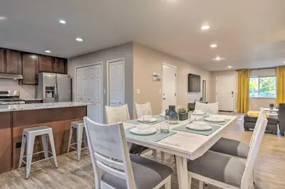 a dining room and kitchen with a table and chairs at Walk to Broncos Stadium Modern Denver Duplex in Denver