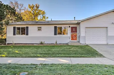 a white house with a red door and a driveway at Walk to Broncos Stadium Modern Denver Duplex in Denver