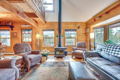 a living room with a couch and a fire place at Deck, Fire Pit and Grill Log Cabin in Black Hawk in Black Hawk