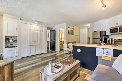 a kitchen and living room with a couch and a table at Ski-InandSki-Out Winter Park Condo with Balcony! in Winter Park