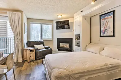 a bedroom with a bed and a chair and a fireplace at Ski-InandSki-Out Winter Park Condo with Balcony! in Winter Park