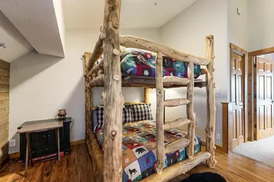 a bedroom with a wooden bunk bed in a room at Knocking at Nature's Door in Keystone