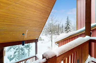 a porch of a cabin with snow on it at Knocking at Nature's Door in Keystone