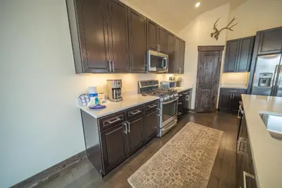 a kitchen with wooden cabinets and a counter top at Alders 42 Outpost Dr by SummitCove Lodging in Keystone