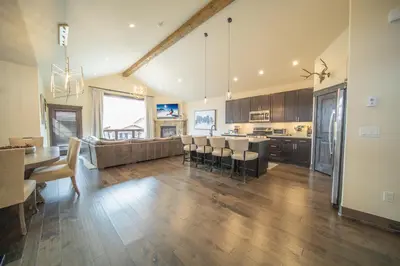 a large kitchen and dining room with a table and chairs at Alders 42 Outpost Dr by SummitCove Lodging in Keystone