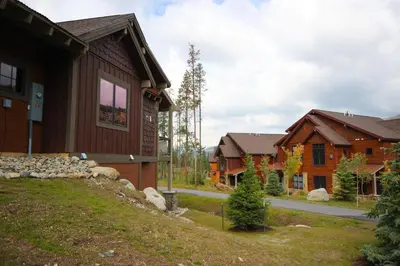 a group of houses in a yard next to a house at Alders 42 Outpost Dr by SummitCove Lodging in Keystone