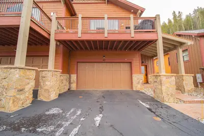 a house with a driveway with a garage at Alders 42 Outpost Dr by SummitCove Lodging in Keystone