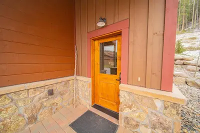 a wooden door on the side of a house at Alders 42 Outpost Dr by SummitCove Lodging in Keystone
