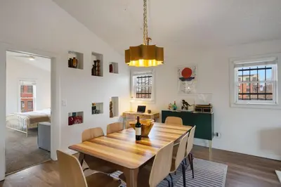 a dining room with a wooden table and chairs at Pine Street Loft Steps from Old Town Square in Fort Collins
