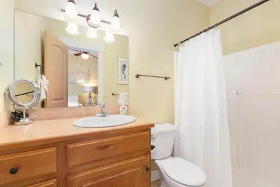 a bathroom with a sink and a toilet and a mirror at Walk Everywhere - Art, Restaurants, Poudre River in Fort Collins