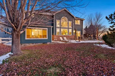 a house with a tree in the yard at Family-friendly Home on Boyd Lake, Gorgeous Views! in Loveland