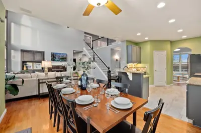 a dining room and living room with a table and chairs at Family-friendly Home on Boyd Lake, Gorgeous Views! in Loveland