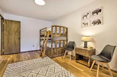a room with a bunk bed and two chairs at 7 Mi to Skiing! Mtn-View Hot Tub Haven in Frisco in Frisco
