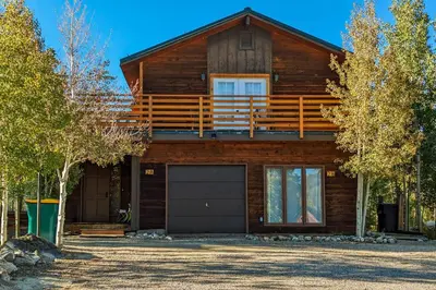 a log house with a garage in front of it at 7 Mi to Skiing! Mtn-View Hot Tub Haven in Frisco in Frisco