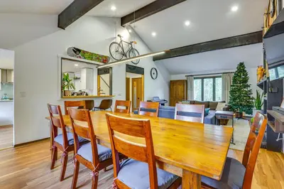 a dining room and living room with a wooden table and chairs at 7 Mi to Skiing! Mtn-View Hot Tub Haven in Frisco in Frisco