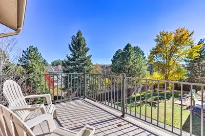 a balcony with two chairs and a fence at Near Shops and Eats! Centennial Escape with Sunroom in Centennial