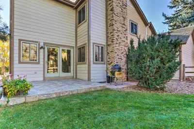 a house with a lawn in front of it at Near Shops and Eats! Centennial Escape with Sunroom in Centennial