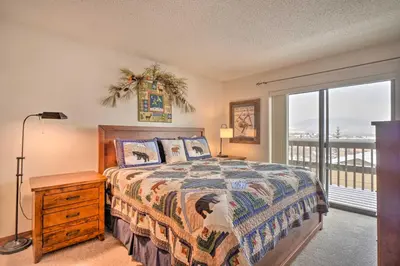 a bedroom with a bed and a large window at Ski, Hike and Explore All-Season Frisco Condo in Frisco