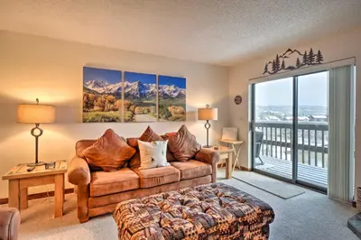 a living room with a couch and a balcony at Ski, Hike and Explore All-Season Frisco Condo in Frisco