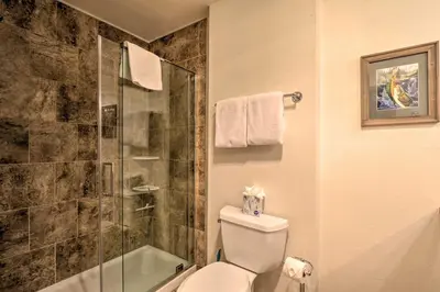 a bathroom with a toilet and a glass shower at Ski, Hike and Explore All-Season Frisco Condo in Frisco