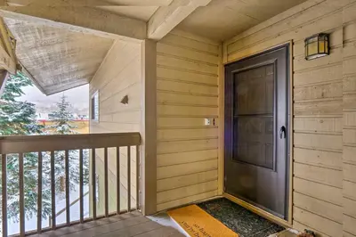 a front door of a house with a porch at Ski, Hike and Explore All-Season Frisco Condo in Frisco