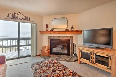 a living room with a flat screen tv and a fireplace at Ski, Hike and Explore All-Season Frisco Condo in Frisco