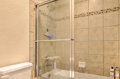a shower with a glass door next to a toilet at Gorgeous Fraser Townhome with Private Hot Tub! in Fraser