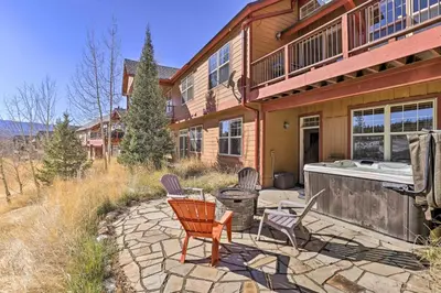 a home with a hot tub and chairs on a patio at Gorgeous Fraser Townhome with Private Hot Tub! in Fraser
