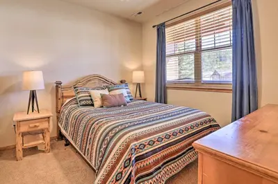 a bedroom with a bed and a window at Gorgeous Fraser Townhome with Private Hot Tub! in Fraser