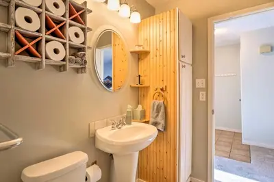 a bathroom with a sink and a toilet and a mirror at 4 Mi to Keystone Resort Dillon Condo with Patio in Dillon