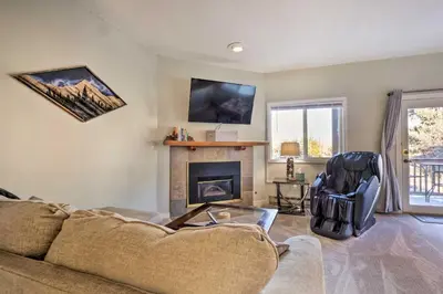 a living room with a couch and a fireplace at 4 Mi to Keystone Resort Dillon Condo with Patio in Dillon