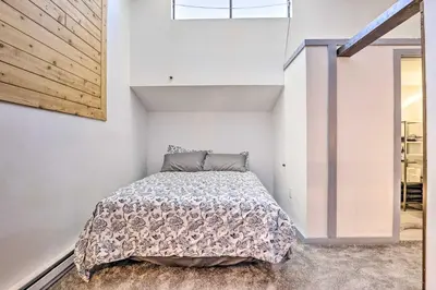 a bedroom with a bed in a white room at Rocky Mtn Retreat 7 Mi to Winter Park Resort in Fraser