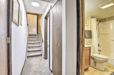 a bathroom with a toilet and a staircase at Rocky Mtn Retreat 7 Mi to Winter Park Resort in Fraser