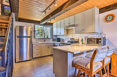 a kitchen with white cabinets and a counter with chairs at Rocky Mtn Retreat 7 Mi to Winter Park Resort in Fraser