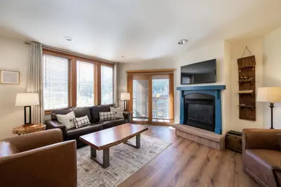 a living room with a couch and a fireplace at Zephyr Mountain Lodge Premium-Rated 2416 in Winter Park