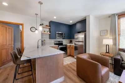 a kitchen with blue cabinets and a counter top at Zephyr Mountain Lodge Premium-Rated 2416 in Winter Park