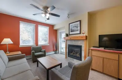 a living room with a couch and a fireplace at Winter Park FF Premium-Rated 3305 in Winter Park