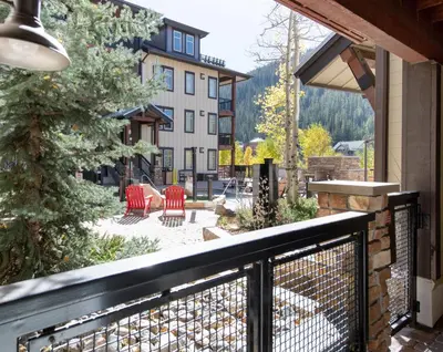 a balcony with red chairs and a patio at Winter Park FF Premium-Rated 3305 in Winter Park