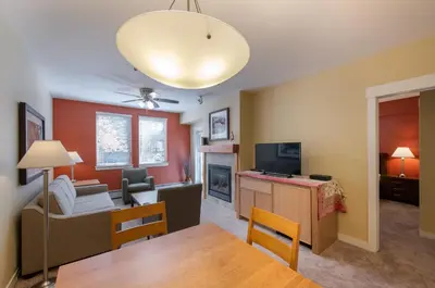 a living room with a couch and a television and a table at Winter Park FF Premium-Rated 3305 in Winter Park
