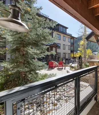 a balcony with a christmas tree and red chairs at Winter Park FF Premium-Rated 3305 in Winter Park
