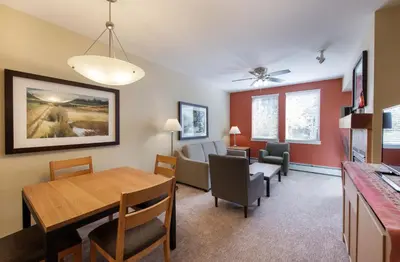 a dining room and living room with a table and chairs at Winter Park FF Premium-Rated 3305 in Winter Park